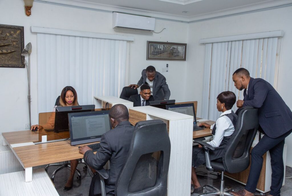 A group of professionals working together in a modern office setting, emphasizing teamwork and productivity.